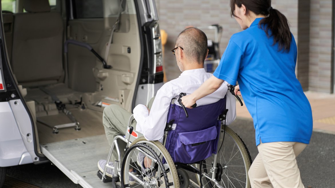 A caregiver who puts an elderly person in a long-term care taxi